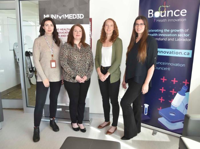 From left are Stephanie Gibbons, Dr. Patricia Cousins, Dr. Sarah Power and Dr. Chandra Kavanagh. The four women are standing in a row, with stand-up banners behind them.